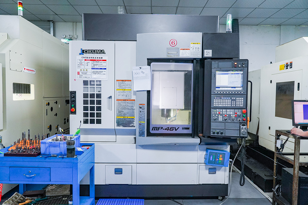 Japan OKUMA MP46V CNC machining centre cutting an injection mould component in the Cents Mould workshop